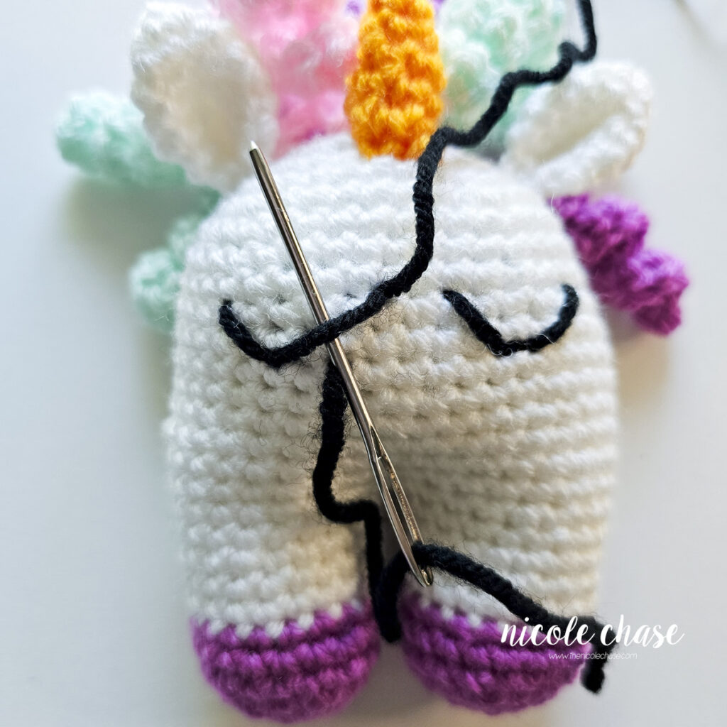 The yarn needle is starting to loop around the straight line again, to further extend the dip.