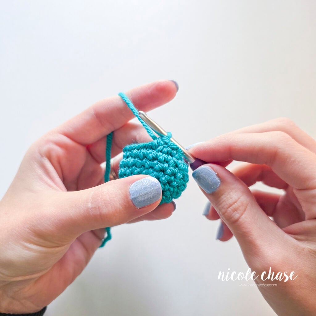 The yarn has been pulled through the final two loops on the hook to complete the invisible decrease.