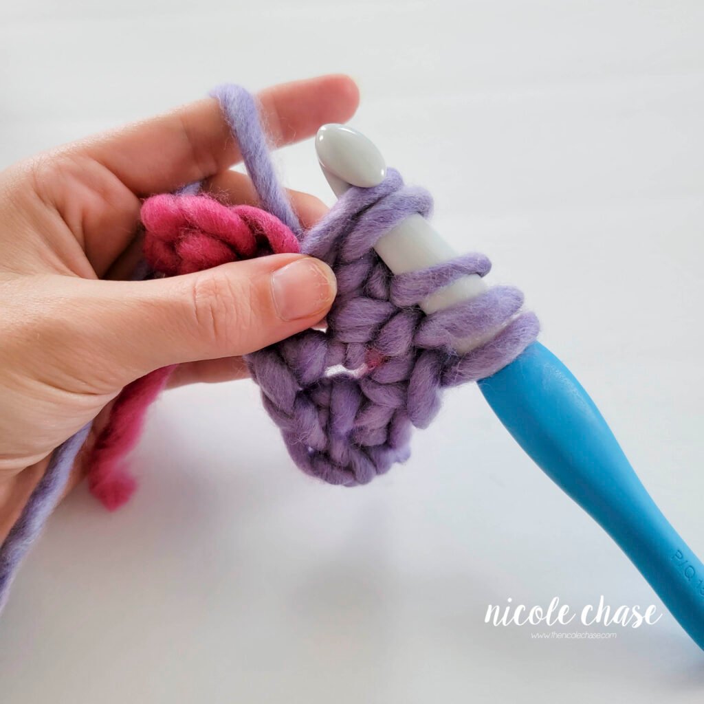 Crochet bobble stitch step 3b: hook showing 4 loops remaining before closing the bobble stitch.