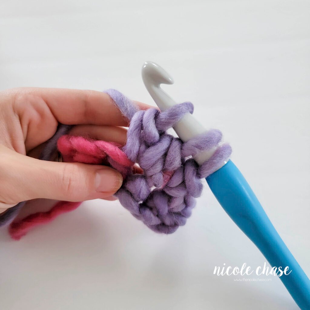 Crochet bobble stitch step 2d: demonstrating the second partial double crochet into the same stitch.