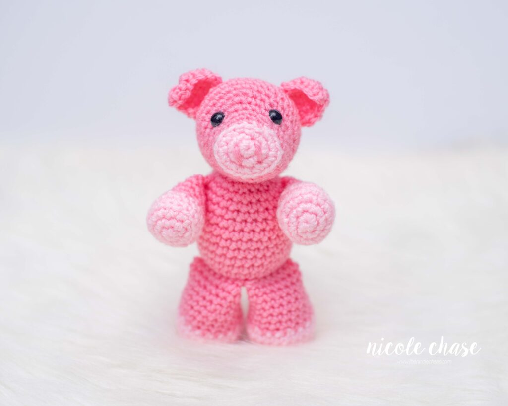pig crochet pattern in pink yarn in a standing position