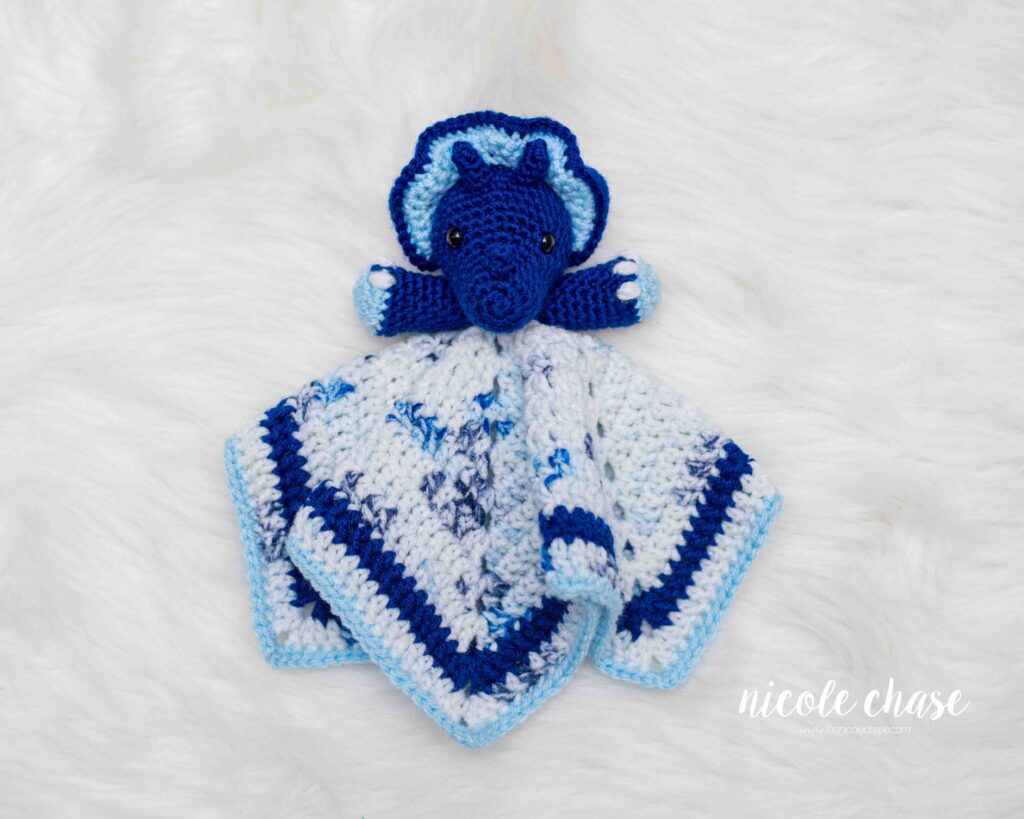 triceratops lovey shown in shades of blue