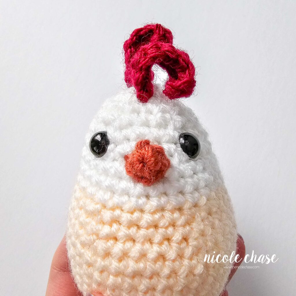 beak attached to the front of the crochet chicken