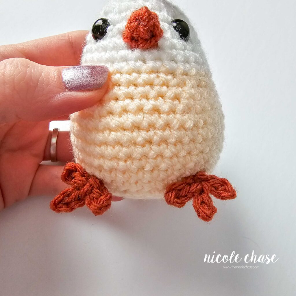 feet pinned to the bottom of the crochet chicken