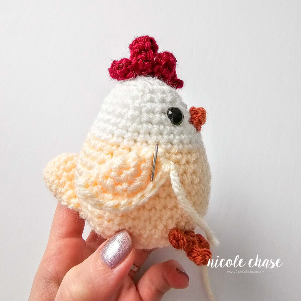 wing pinned to the side of the crochet chicken