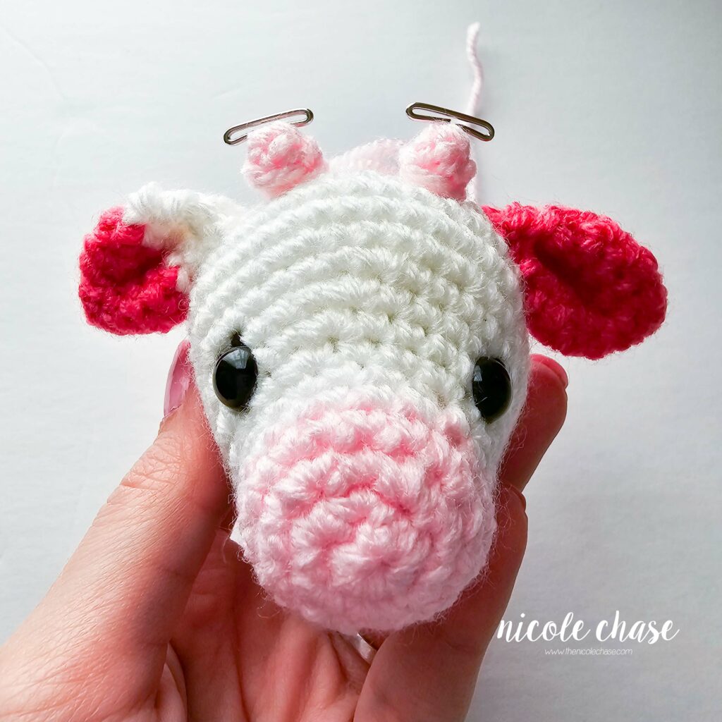 crochet cow head with horns pinned in place