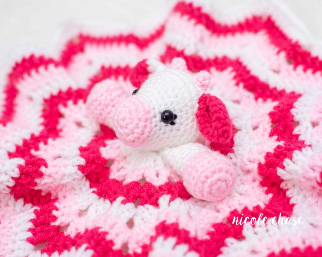 crochet cow lovey pattern shown in shades of pink