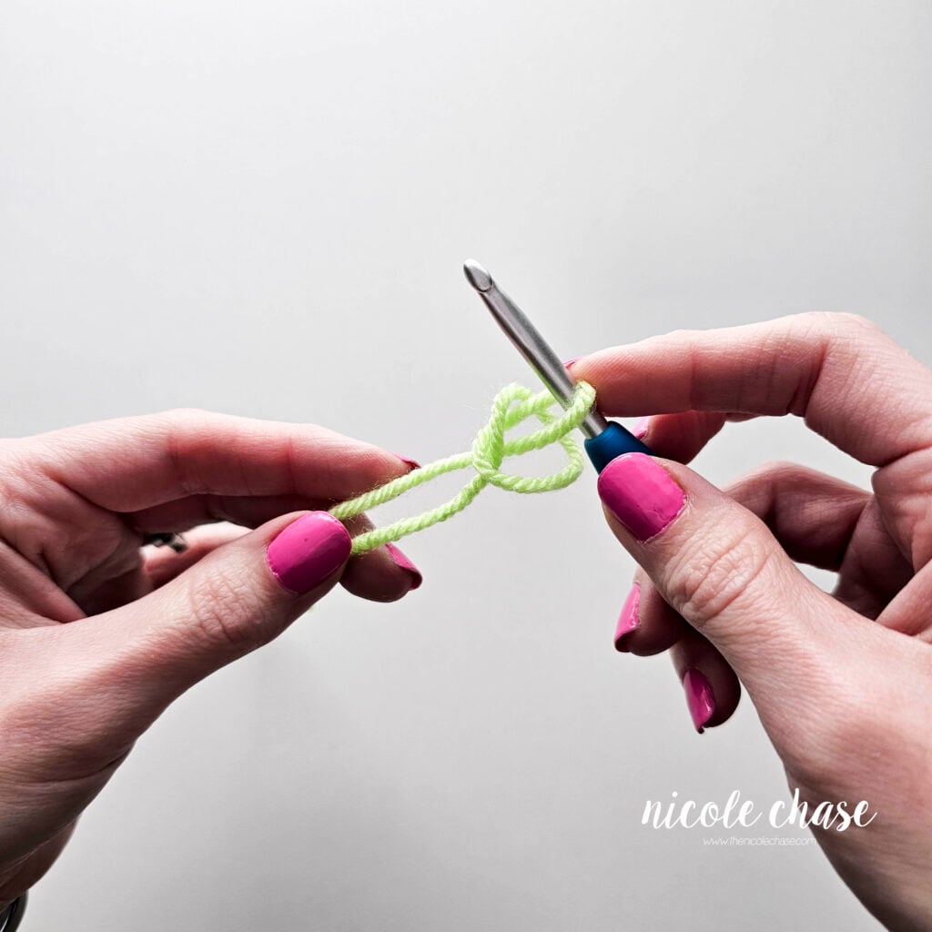 Carefully pull the two strands of yarn (working yarn and yarn tail) to create the slip knot.