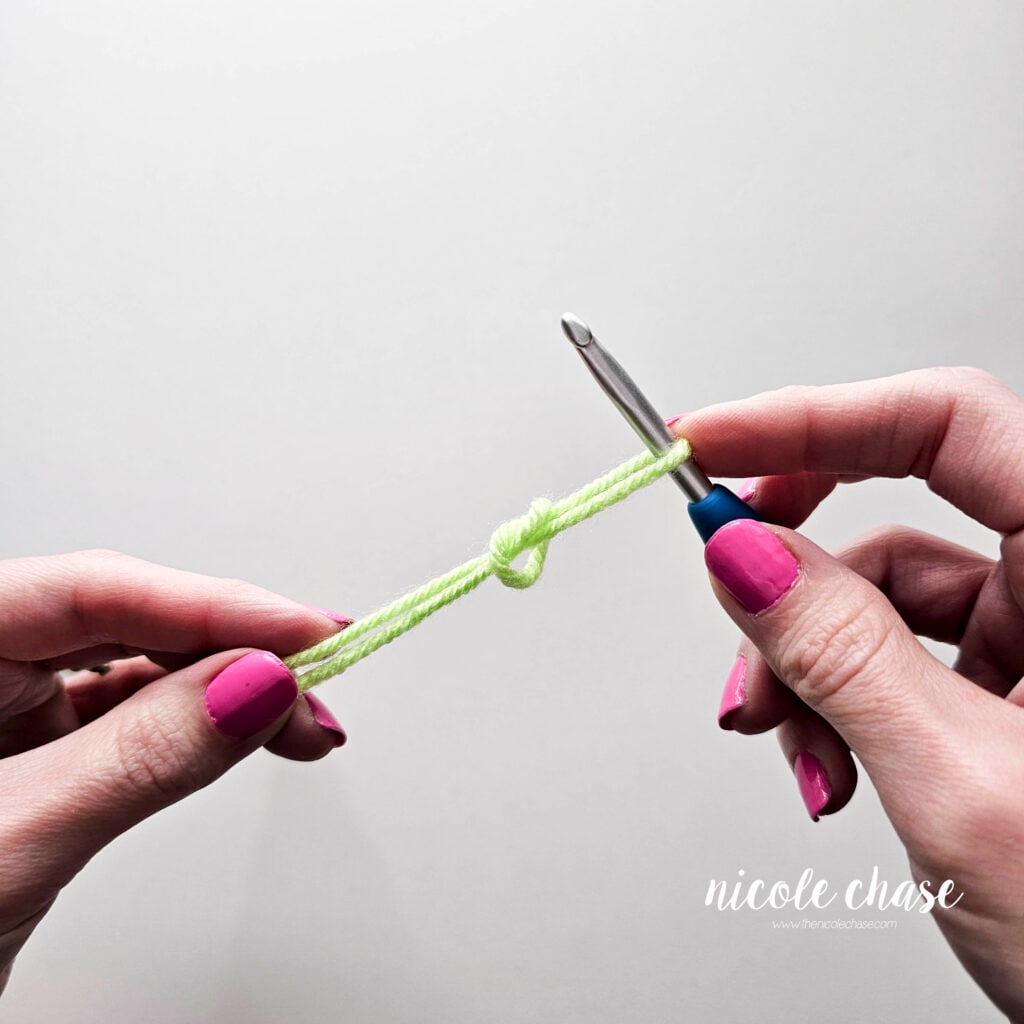 Continue pulling the two strands of yarn until the slip knot is tight.