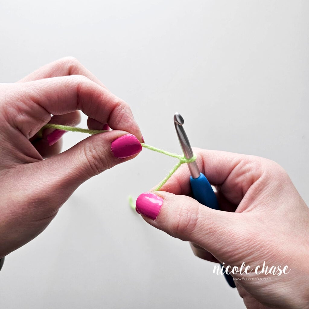 The slip knot has been tightened against the crochet hook.