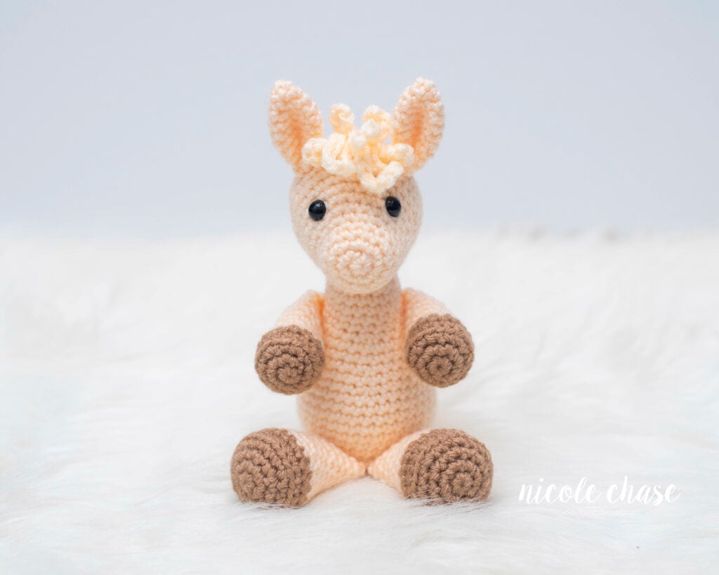 free llama crochet pattern with cream yarn and brown accents