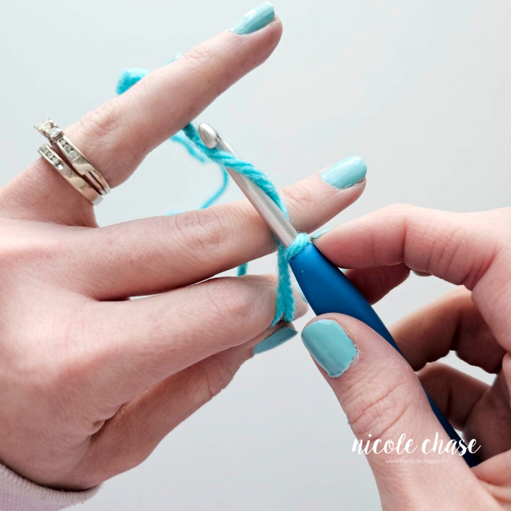 The working yarn has been wrapped around the hook to start a chain.