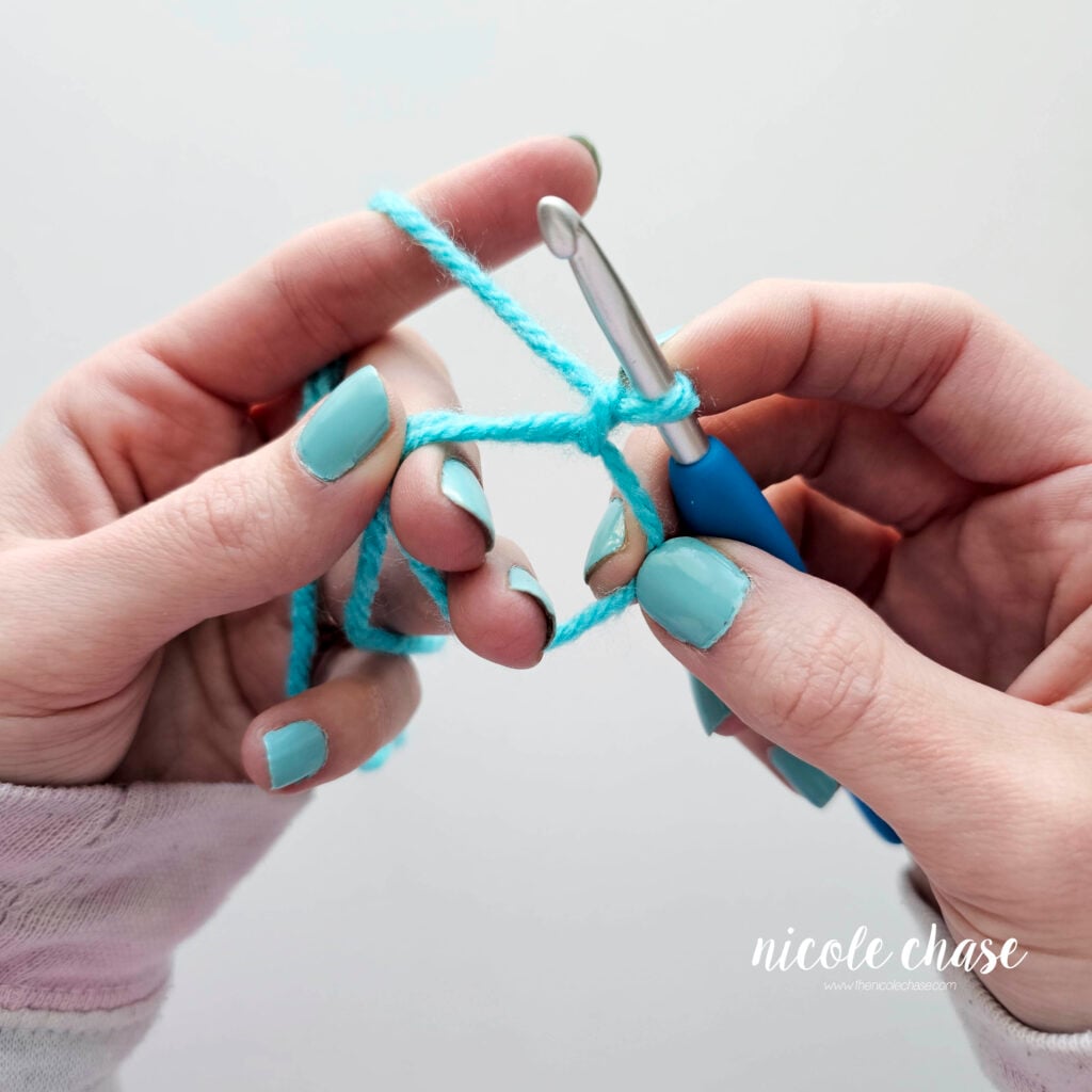 The magic ring is in place and the working yarn is wrapped around the pointer finger for tension.