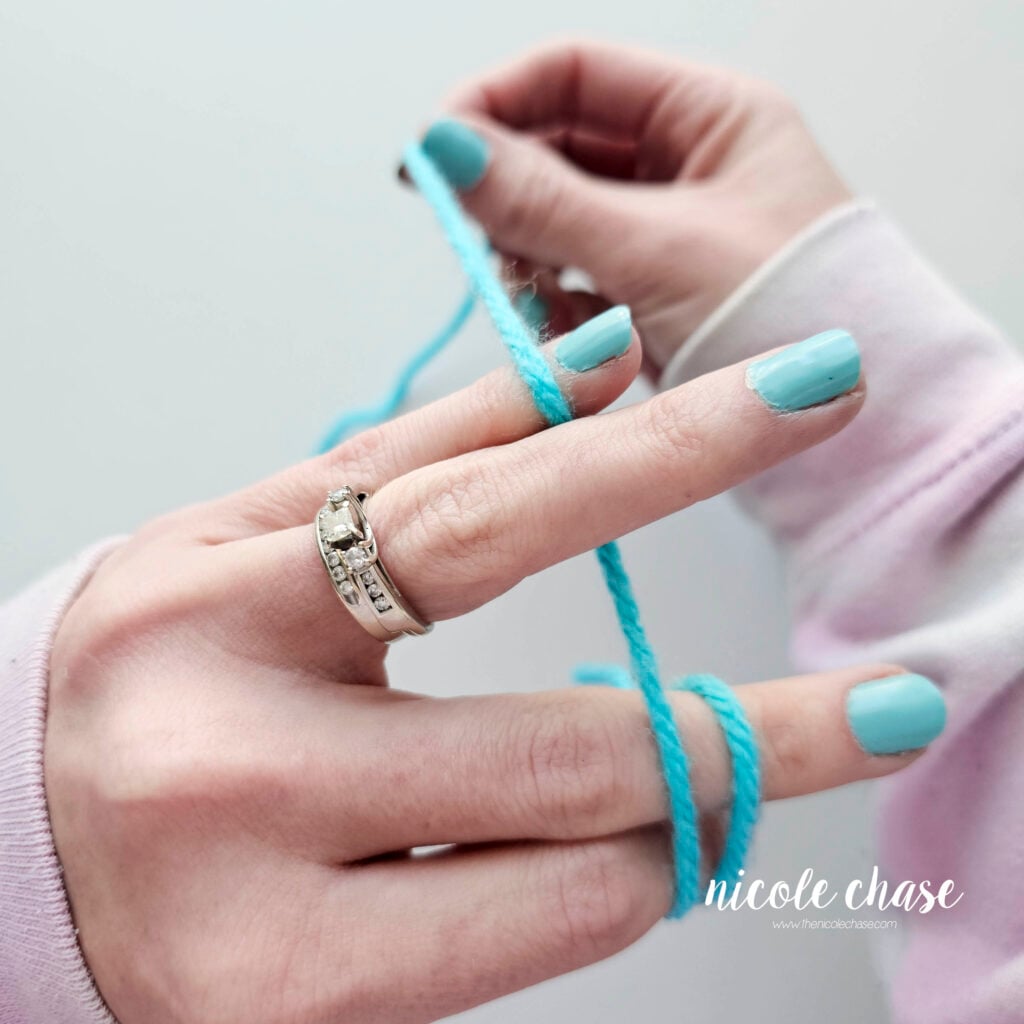 Photo showing the working yarn being held with the pinky and ring finger.
