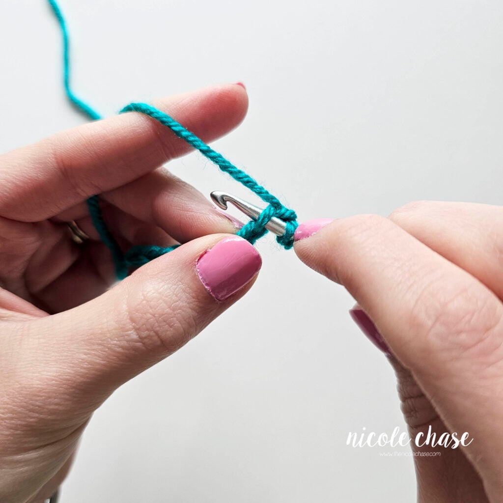The crochet hook has been inserted into the second chain from the hook, and this is where the first single crochet will be worked.