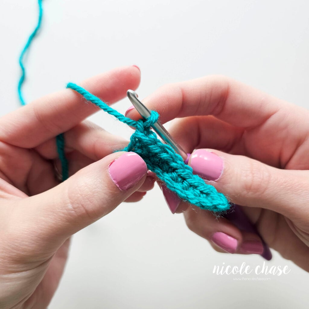 Demonstrating how to single crochet in rows by creating a turning chain at the end of your row.