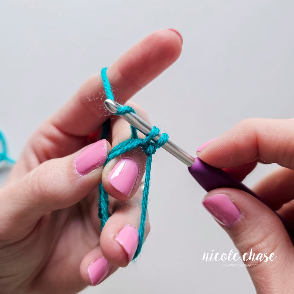 There are two loops on the hook and the yarn is wrapped over the hook.