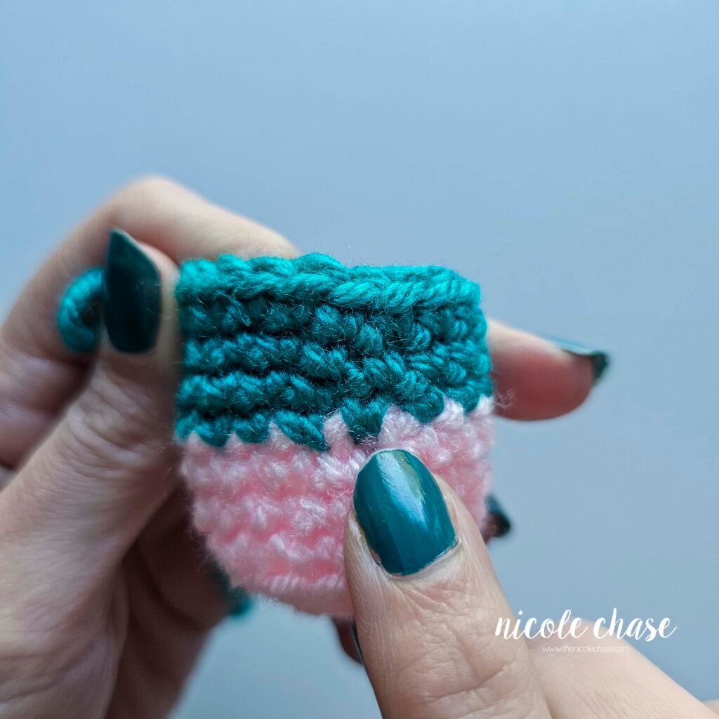 Final close-up of the completed crochet invisible color change in amigurumi, showing a perfectly smooth and seamless color transition without a visible jog or step.