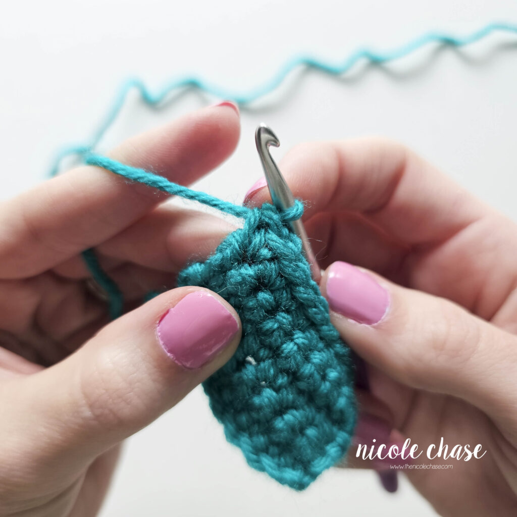 Tutorial photo showing the second single crochet worked into the identical space as the first, completing a single crochet increase to widen the row.
