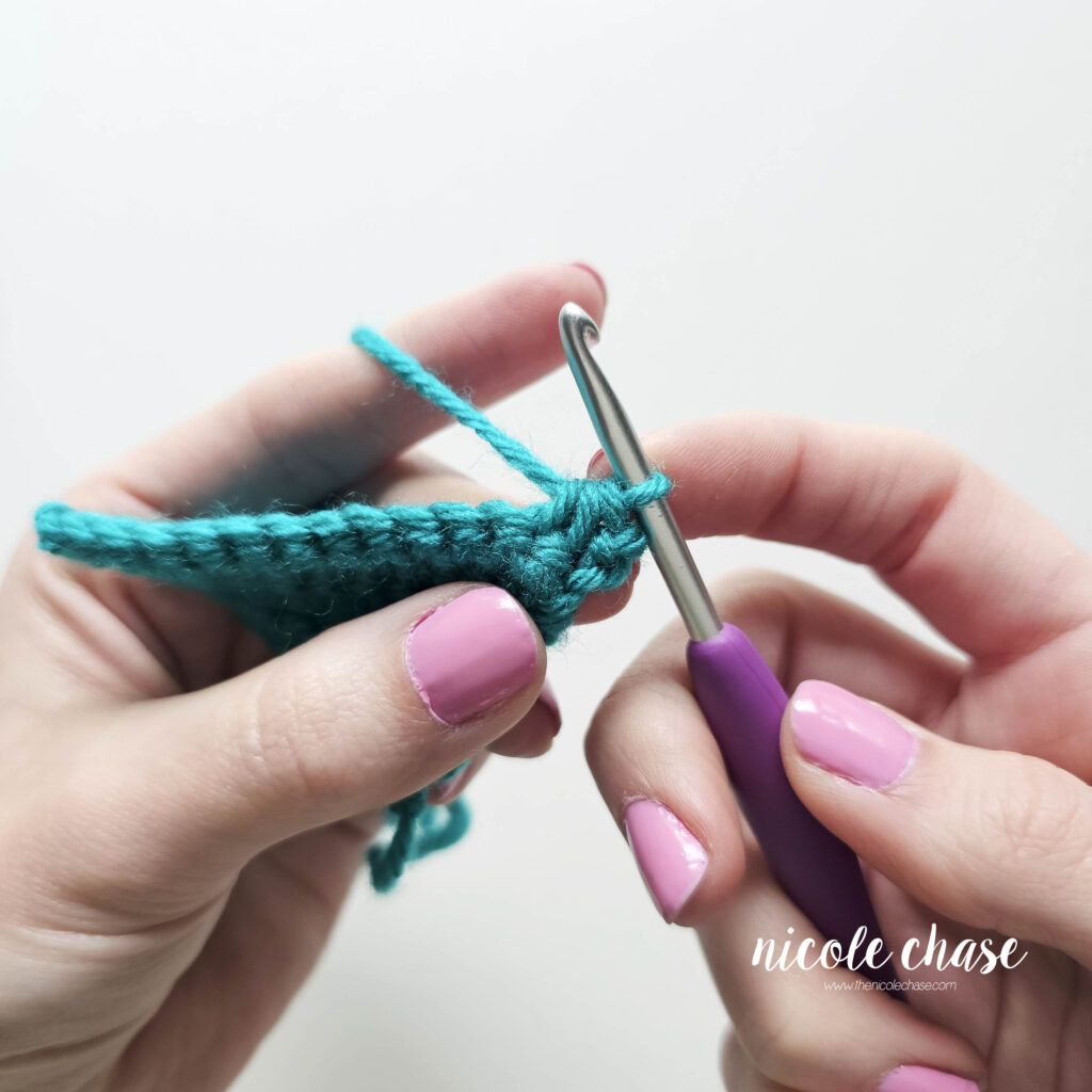 Tutorial image showing the finished single crochet decrease stitch, demonstrating how the fabric tapers as two stitches are successfully worked together into one.