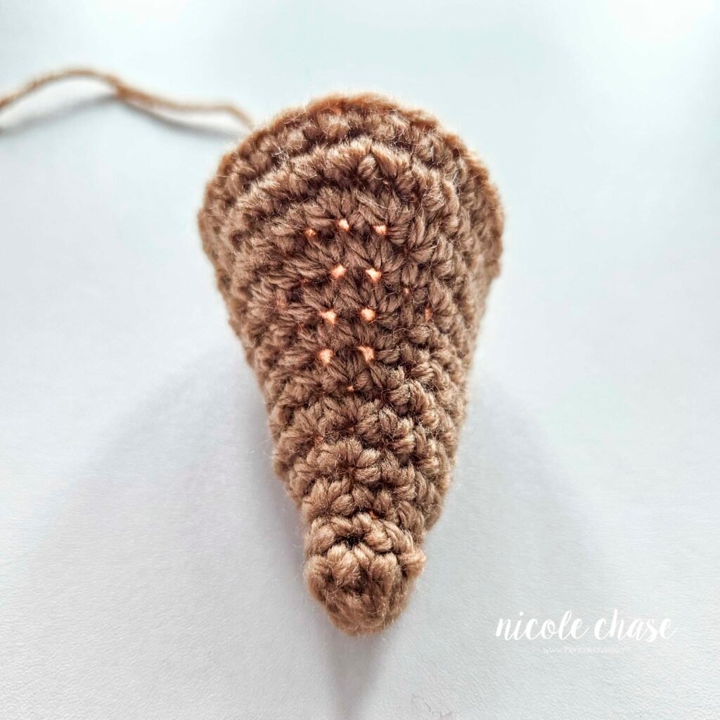 The head of the crochet mouse after R13, prior to the insertion of the safety eyes.