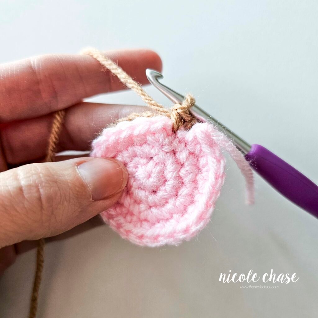 Joining the inner ear and outer ear together for the amigurumi mouse crochet pattern, step 6.