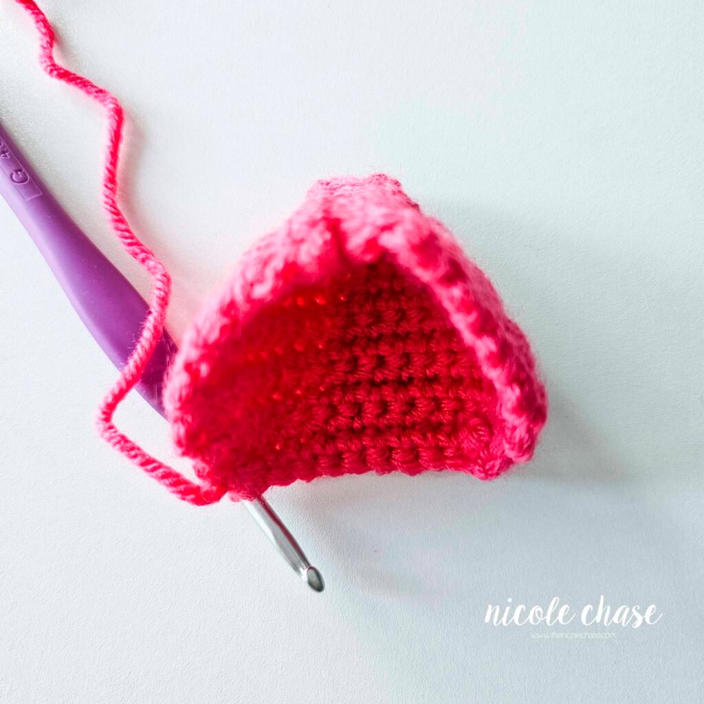 The crochet hood for the mouse's sweatshirt showing the start of crocheting around the edge of the hood. 