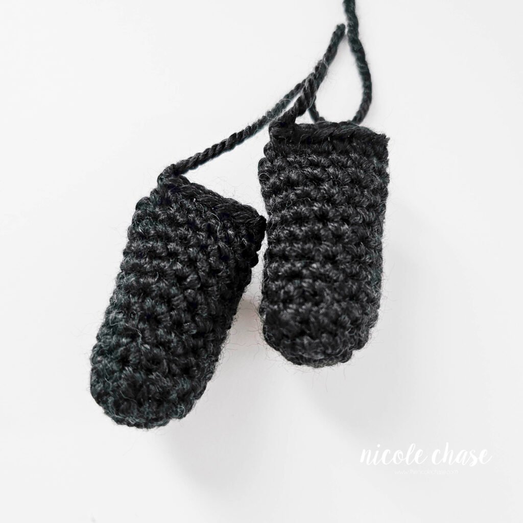 Completed crochet legs for the black cat amigurumi. 