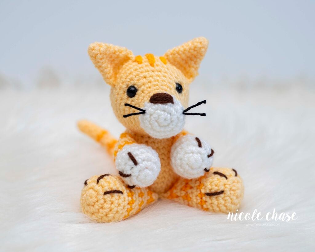 A finished crochet cat, made with the free cat crochet pattern called Cooper. 