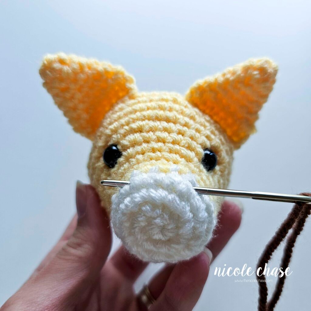Embroidering the nose on the cat crochet pattern, step 1.