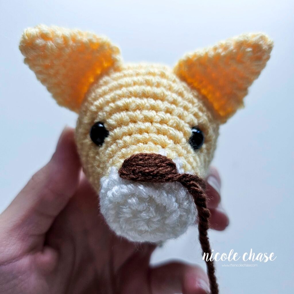 Embroidering the nose on the cat crochet pattern, nearly finished. 