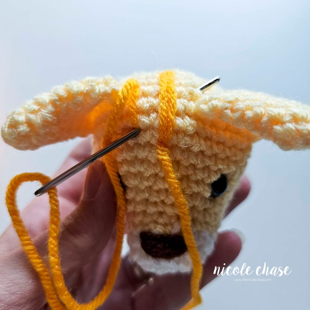Embroidering the third stripe on the cat crochet pattern, step 1. 