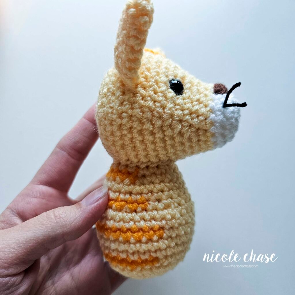 Side view of the cat's head sewn in place. 