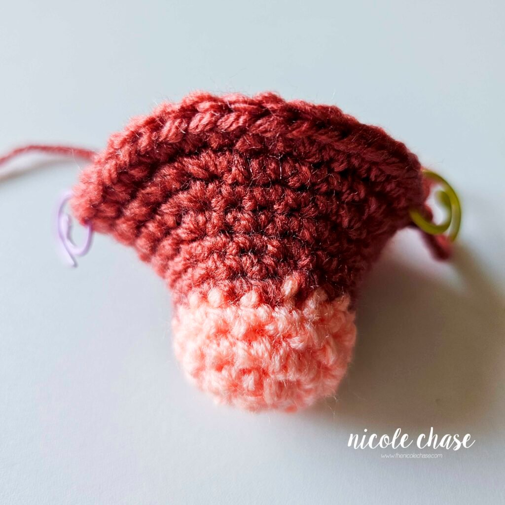 Crochet head of ankylosaurus amigurumi where the eyes will be placed after R11.