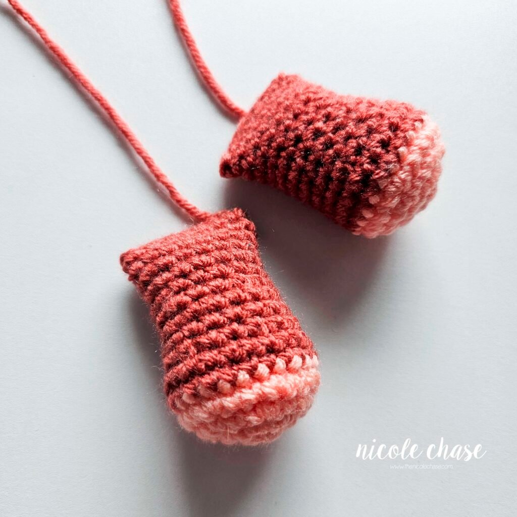 Finished leg pieces of the free small dinosaur crochet pattern for Mini Archie the Ankylosaurus.