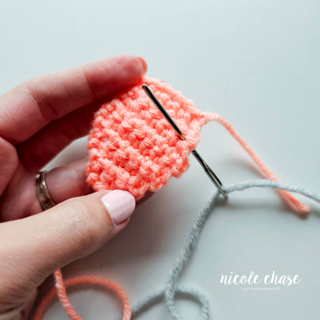 Embroidering the bumps on the back plate of the crochet ankylosaurus, step 1.