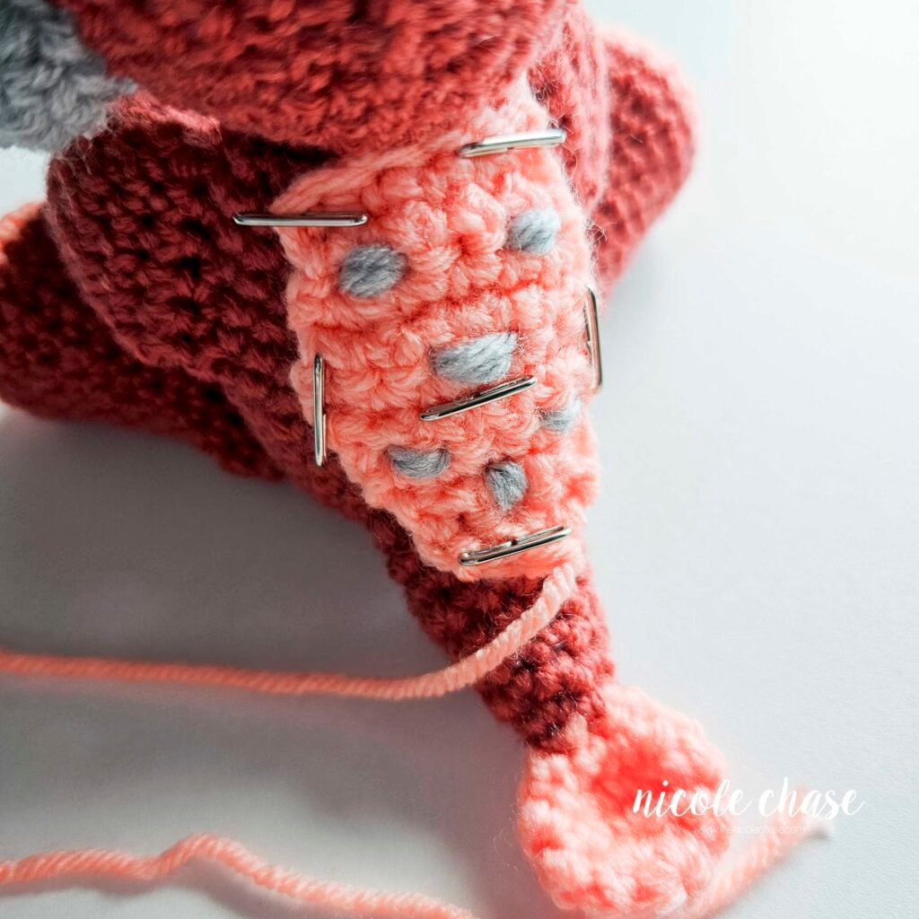 Back plate held in place by pins on the back of the crochet ankylosaurus amigurumi.