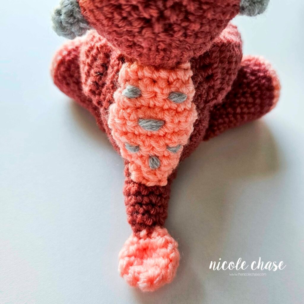 Back plate sewn into place on the back of the crochet ankylosaurus pattern, view 2.
