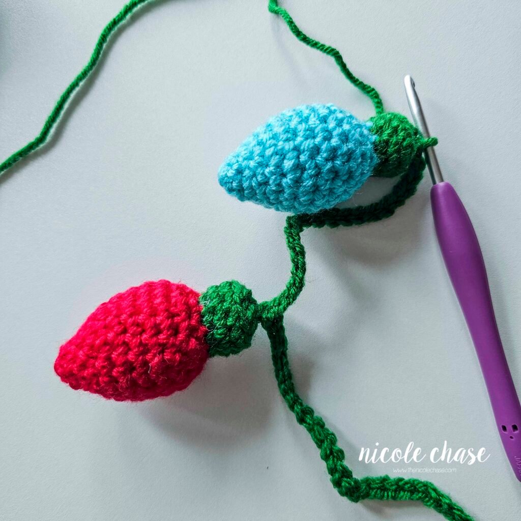 Attaching the next crochet Christmas light to the garland. 