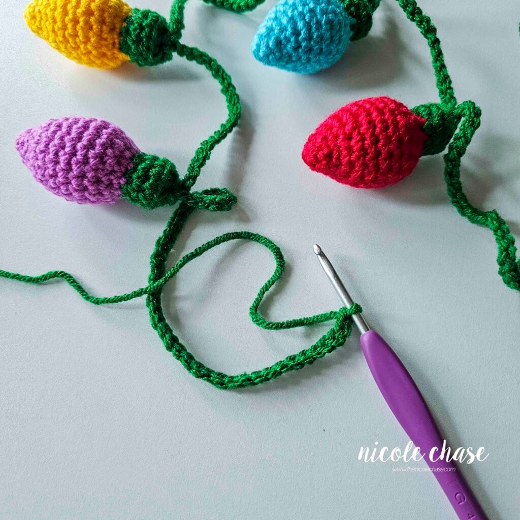 After attaching all of the crochet Christmas lights to the garland, ending with a long chain. 