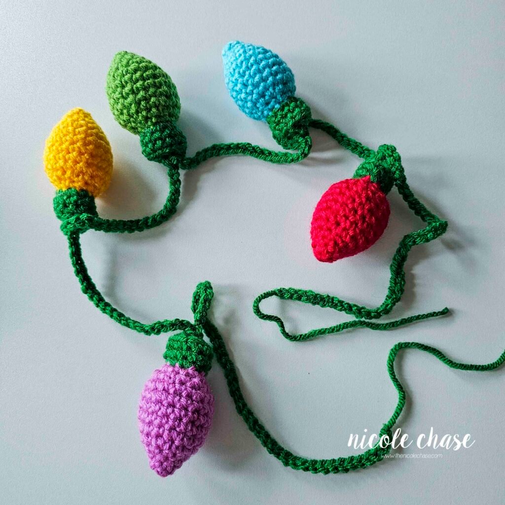 Fastening off the end of the long green chain for the crochet holiday lights pattern. 