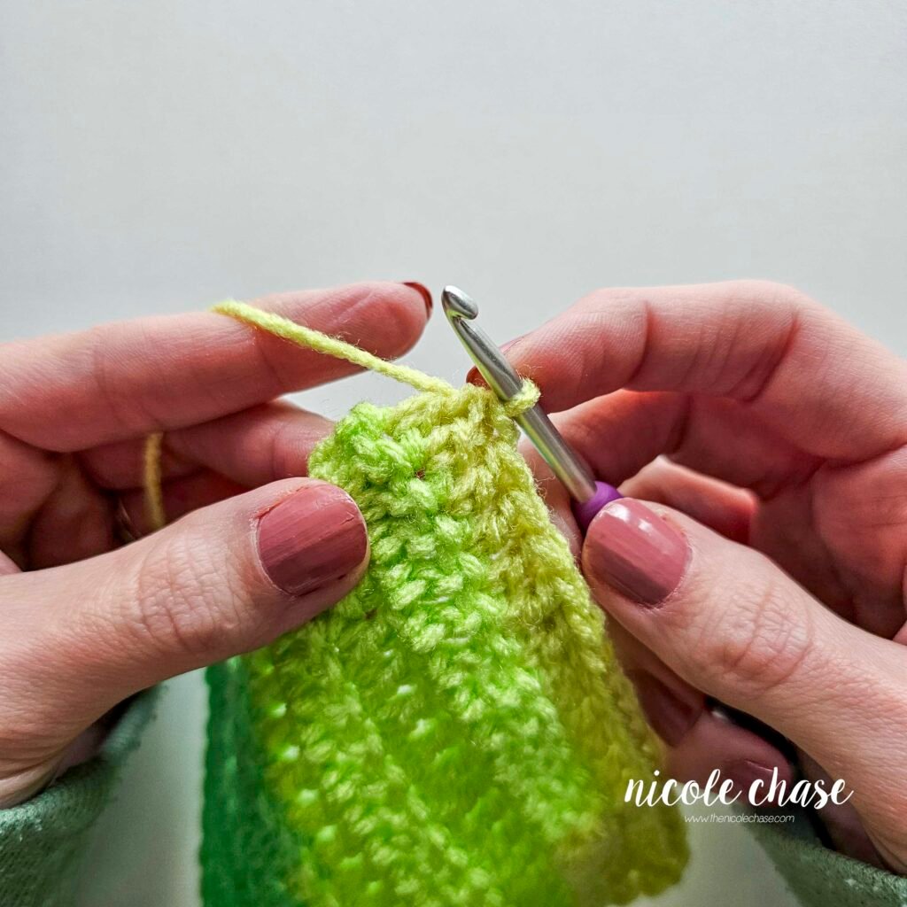 The double crochet swatch after a dc decrease or dc2tog has been added to the end of the row.