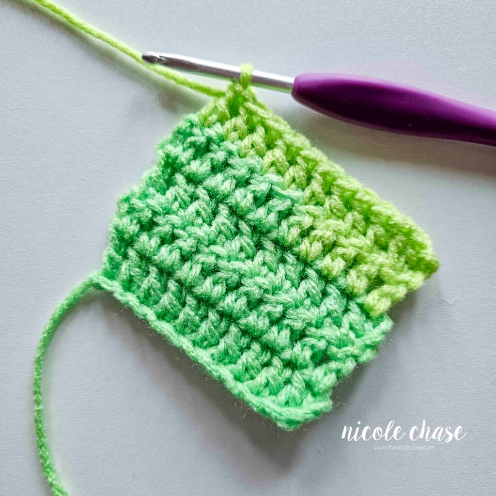 Swatch of double crochet stitches after the first stitch of the dc increase.