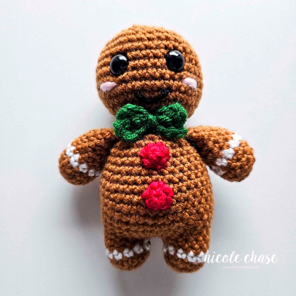The bow tie has been sewn into place on the free gingerbread crochet pattern. 