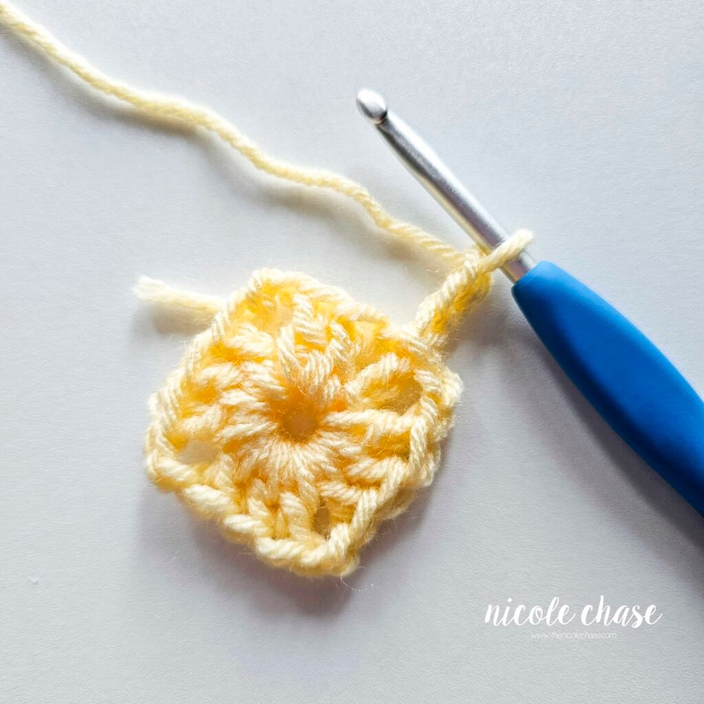 R2 of crocheting the blanket portion of the lion lovey crochet pattern in light yellow yarn, part 1.