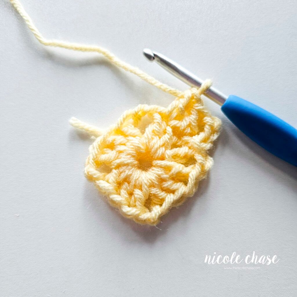 R2 of crocheting the blanket portion of the lion lovey crochet pattern in light yellow yarn, part 2.