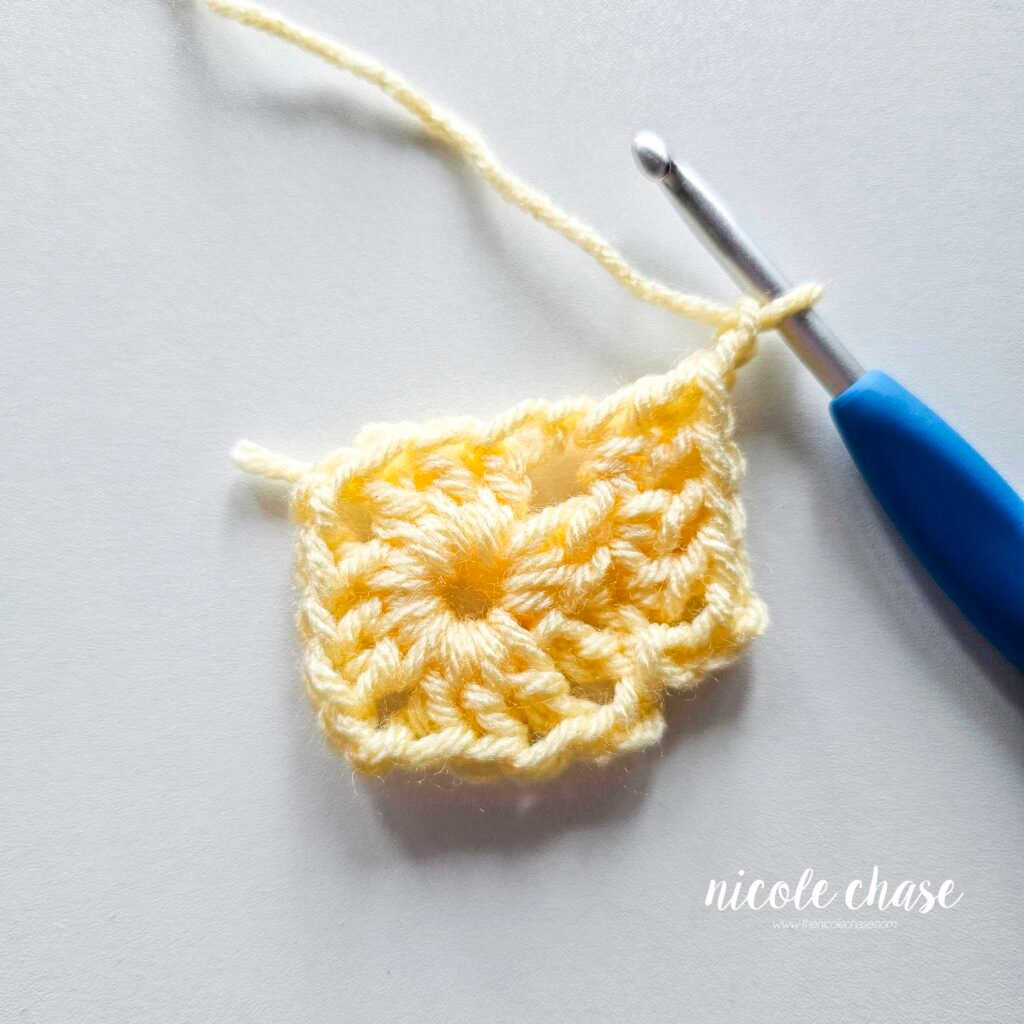 R2 of crocheting the blanket portion of the lion lovey crochet pattern in light yellow yarn, part 4.