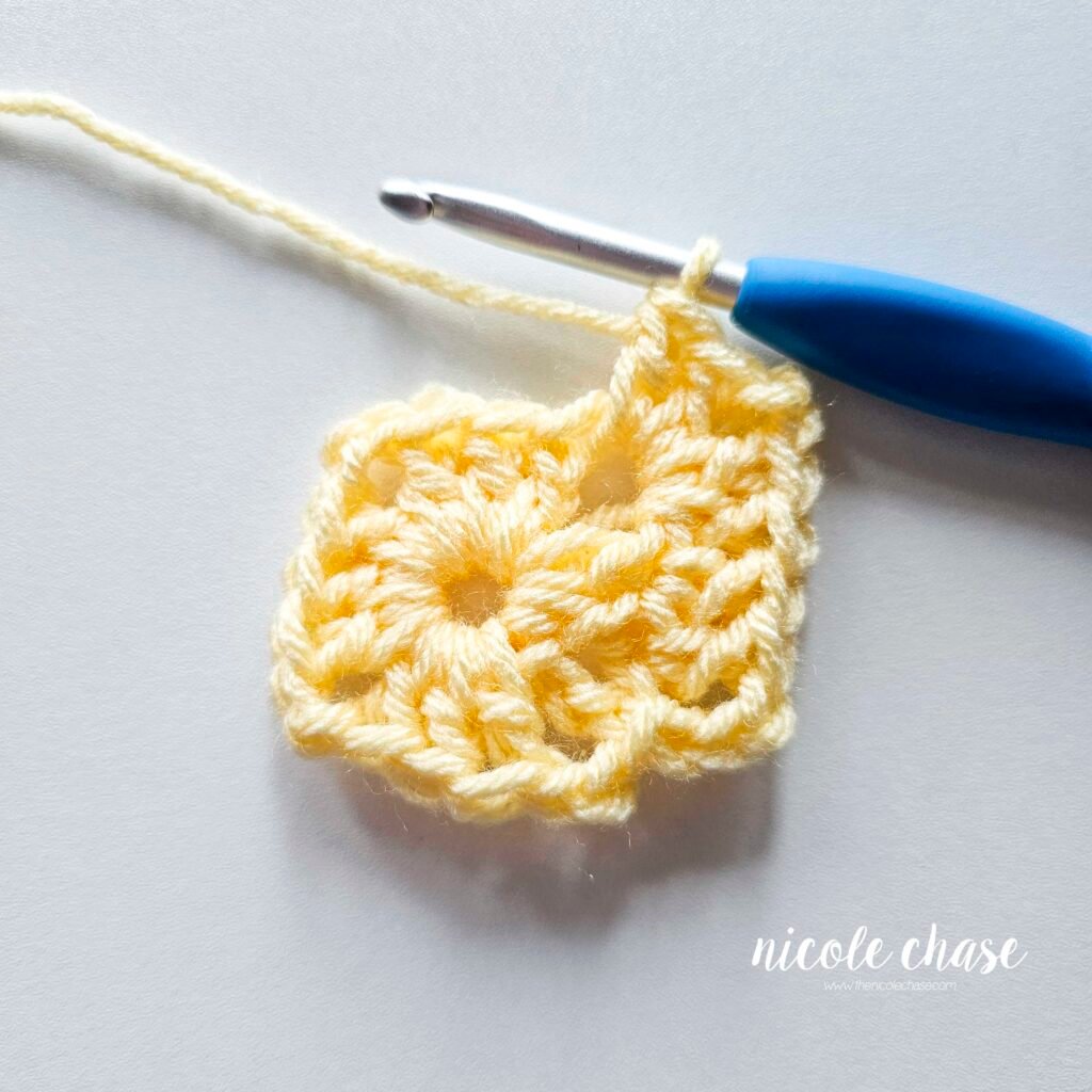 R2 of crocheting the blanket portion of the lion lovey crochet pattern in light yellow yarn, part 5.