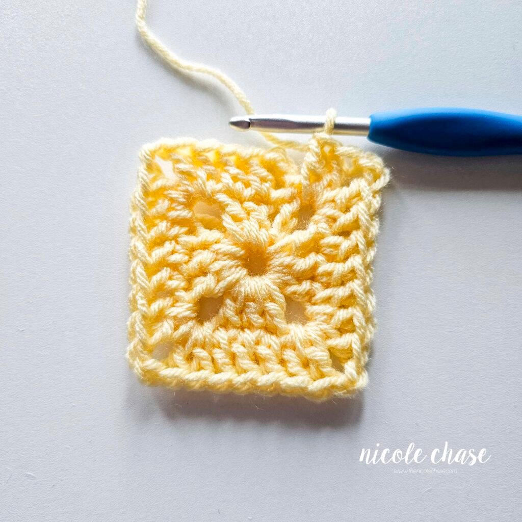 R2 of crocheting the blanket portion of the lion lovey crochet pattern in light yellow yarn, part 7.