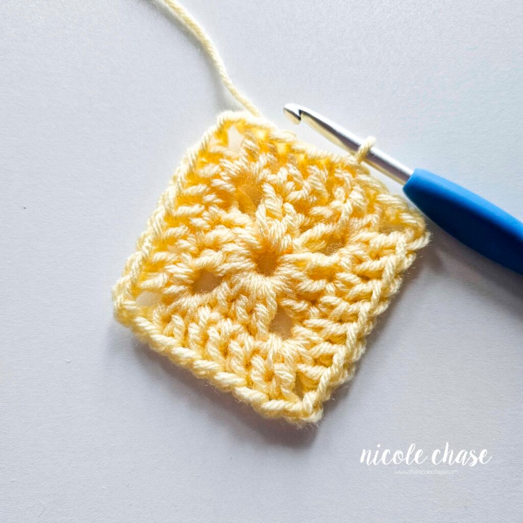 R2 of crocheting the blanket portion of the lion lovey crochet pattern in light yellow yarn, part 8.